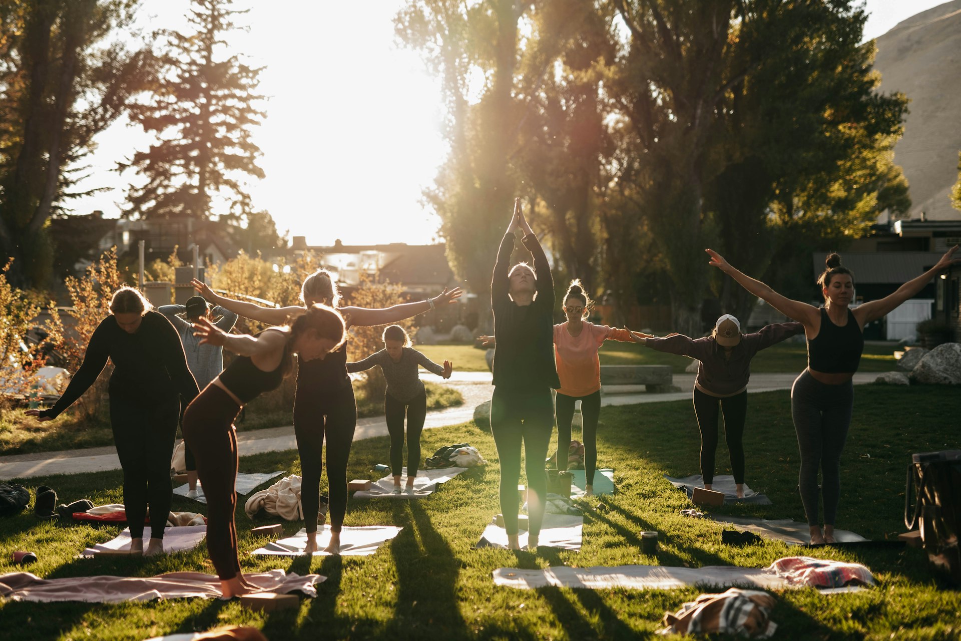 a group of people doing yoga in a park